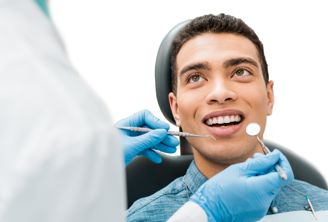 A smiling man receiving dental care.